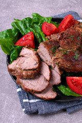 Roasted pork neck served with vegetables and cut into slices. Hot meat meal with spices
