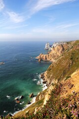 Fototapeta na wymiar Aerial view of majestic cliffs and tranquil blue sea. Cabo da Roca, Portugal.