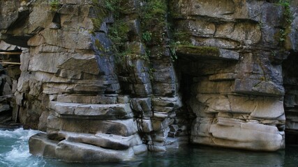 Large rock formation surrounded by water