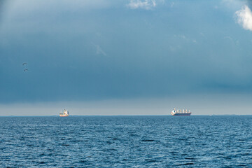 Baltic Sea at the bay of Finland with sun setting on the horizon large ships in the Baltic Sea on...