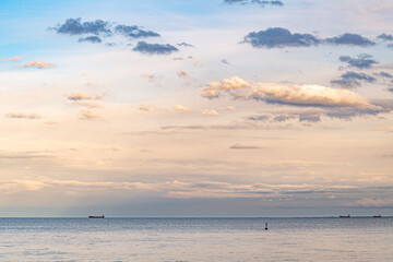 Baltic Sea at the bay of Finland with sun setting on the horizon large ships in the Baltic Sea on the roadstead 
