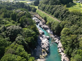 Scenic river running through a mountainous region surrounded by lush forestry
