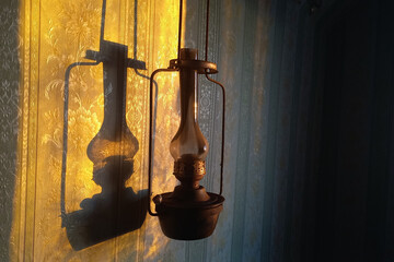An antique kerosene lamp hangs on the wall.
