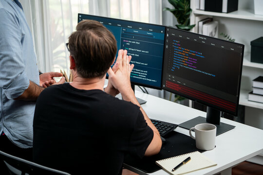 IT developers discussing online software development information on pc screen, creating program coding for latest version application on website. Concept of brainstorming firmware updated. Sellable.
