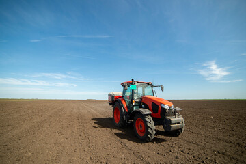 Obraz premium Tractor spreading artificial fertilizers