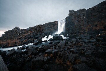 A waterfall on black stone photographed in the south of Iceland during October.