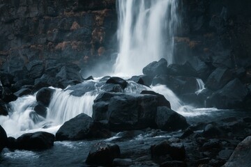 Long-Time-Exposure waterfall on black rocks in the south of Iceland during October.