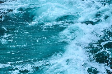 Beautiful blue ocean with white-crested waves viewed from above