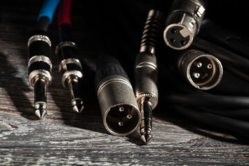 audio xlr trs cable plugs on wood background - 771525804