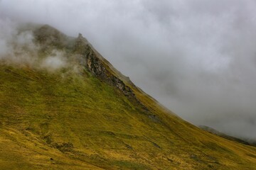 Peaceful scene of mountainous terrain featuring lush green grass and rocky outcrops in Georgia