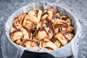 Chocolate Babka before and after baking. Stuffed with chocolate cream. Copy space.