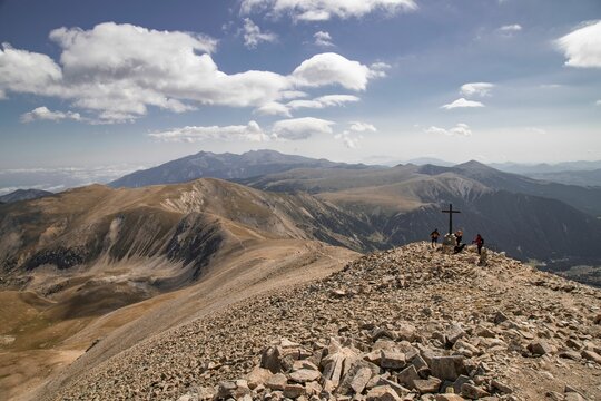 Scenic view of Bastiments Peak in the Catalan Pyrenees, with lush green meadows and rocky terrain