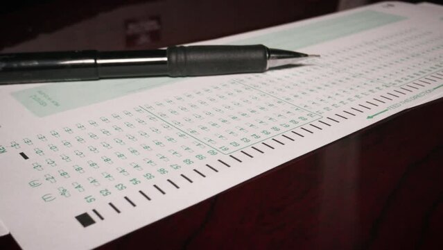 2 close up multiple choice exam student testing with pencil paper