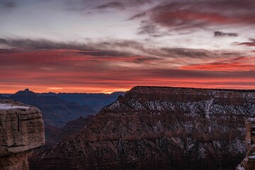 a mountain landscape at sunset with a lone man and a few birds