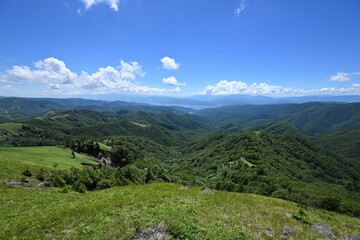 Scenic view of green mountains on a sunny day