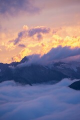 Fototapeta na wymiar Vertical shot of sunset clouds over the Alps in Switzerland