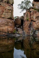 Scenic natural landscape featuring an array of rocky formations and vegetation in a tranquil lake