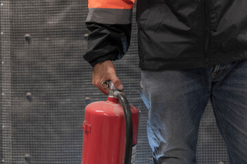 man with extinguisher on fire. person with extinguisher. Engineer checking Control Panel of fire...