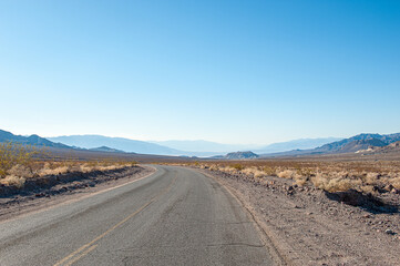 Fototapeta na wymiar Driving in Death Valley. Death Valley National Park in Inyo County of Mojave Desert, California is the hottest place on earth with a temperature of 56,7 °C recorded in 1913.