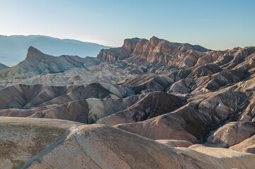 View from Zabriskie Point at dusk. Death Valley National Park in Inyo County of Mojave Desert, California is the hottest place on earth with a temperature of 56,7 °C recorded in 1913. - 771542251