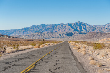 Driving in Death Valley. Death Valley National Park in Inyo County of Mojave Desert, California is the hottest place on earth with a temperature of 56,7 °C recorded in 1913. - 771542277