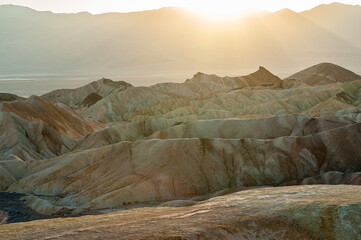 View from Zabriskie Point at dusk. Death Valley National Park in Inyo County of Mojave Desert, California is the hottest place on earth with a temperature of 56,7 °C recorded in 1913. - 771542298