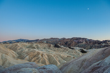 View from Zabriskie Point at dusk. Death Valley National Park in Inyo County of Mojave Desert, California is the hottest place on earth with a temperature of 56,7 °C recorded in 1913. - 771542434