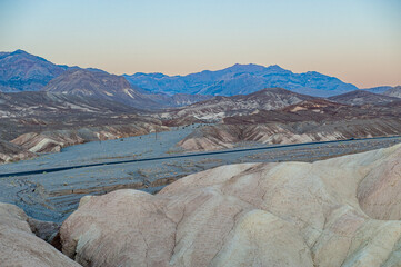 View from Zabriskie Point at dusk. Death Valley National Park in Inyo County of Mojave Desert, California is the hottest place on earth with a temperature of 56,7 °C recorded in 1913. - 771542435