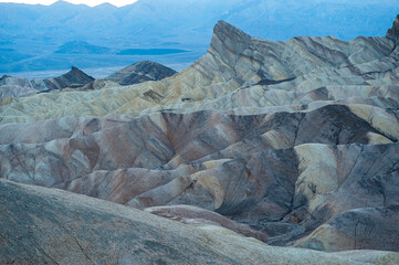 View from Zabriskie Point at dusk. Death Valley National Park in Inyo County of Mojave Desert, California is the hottest place on earth with a temperature of 56,7 °C recorded in 1913. - 771542440