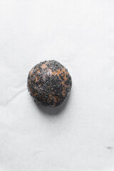 Overhead view of black sesame sugar cookie dough, sesame  coated sugar cookie dough on parchment...