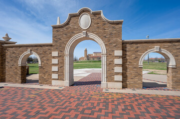Wall and arches with the arena and its tower on the campus of Texas Tech University in the city of...