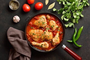 Georgian chicken stew with tomatoes and herbs. Top view, flat lay
