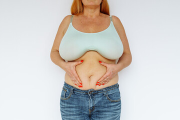 Overweight woman showing fat belly - obrazy, fototapety, plakaty