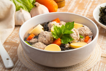 Thai style Clear seaweed soup with glass noodle, Minced Pork,Vegetables and egg tofu in white...