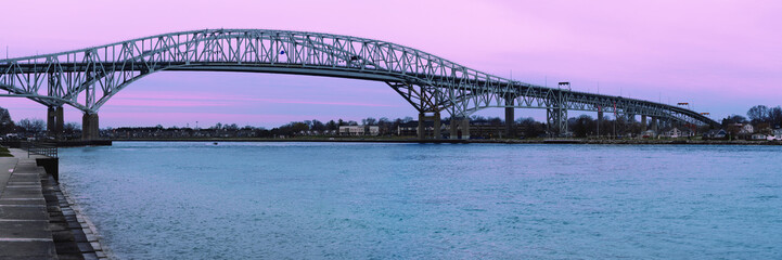 Sunrise over the Blue Water Bridge, a twin-span international bridge over the St. Clair River,...