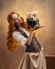 Portrait of a red-haired girl in steampunk style with a vintage camera