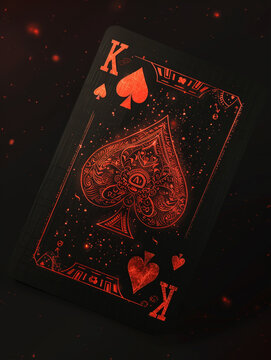 A king of hearts playing card float midair with a matte black background
