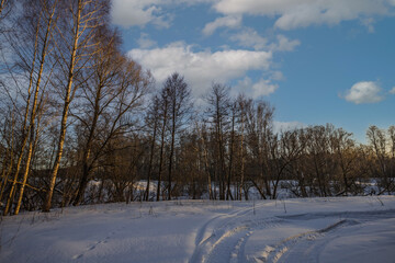 the trail of a snowmobile in the impassable snows of winter nature