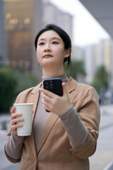 Modern Professional Woman Using Smartphone Outside