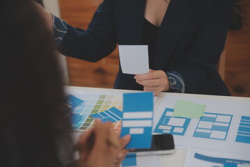 Close up ux developer and ui designer use augmented reality brainstorming about mobile app...
