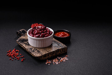 Canned red beans with salt and spices in a white bowl