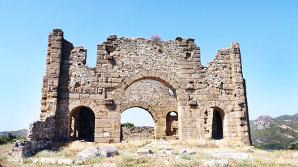 Aqueduct and basilicas behind the historical Aspendos Ancient Theater in Antalya, Turkey