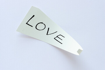 paper shape with 3d curl edges and the word love on blank paper