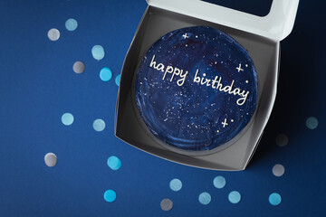 Birthday little cake with blue cream cheese frosting decorated with happy birthday text on top....