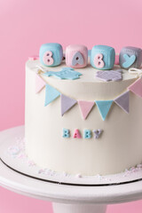 Baby shower party cake with white chocolate frosting. Guess the gender of the upcoming child. He or...