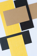 geometric paper background featuring black, yellow, and brown paper elements arranged in grid like...