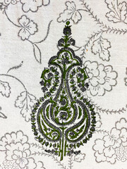 Intricate mughal paisley design in green and grey on cream cotton with grey outline floral block...