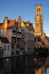 Fototapeta premium BRUGES, BELGIUM-NOVEMBER 16, 2022: View from Rozenhoedkaai (the Quay of the Rosary) to the iconic clock tower Belfort (Belfry) and old hanseatic buildings