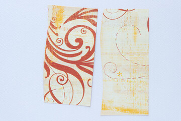 two pieces of scrapbooking paper featuring floral elements on blank paper