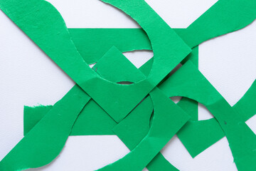cut green paper shapes (with curvy cutout) on blank paper